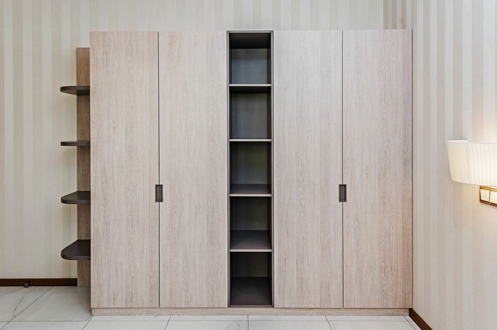 A Bedroom With a Large Wooden Wardrobe and Shelves — Bruce Smith Cabinets in Bray Park, NSW