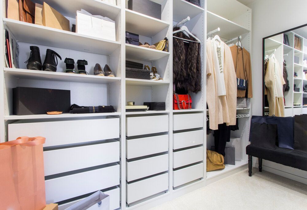 A Walk in Closet Filled With Lots of Clothes and Shoes — Bruce Smith Cabinets in Byron Bay, NSW