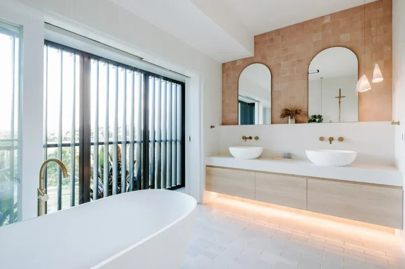 A Bathroom With Two Sinks, a Bathtub and a Large Window — Bruce Smith Cabinets in Bray Park, NSW