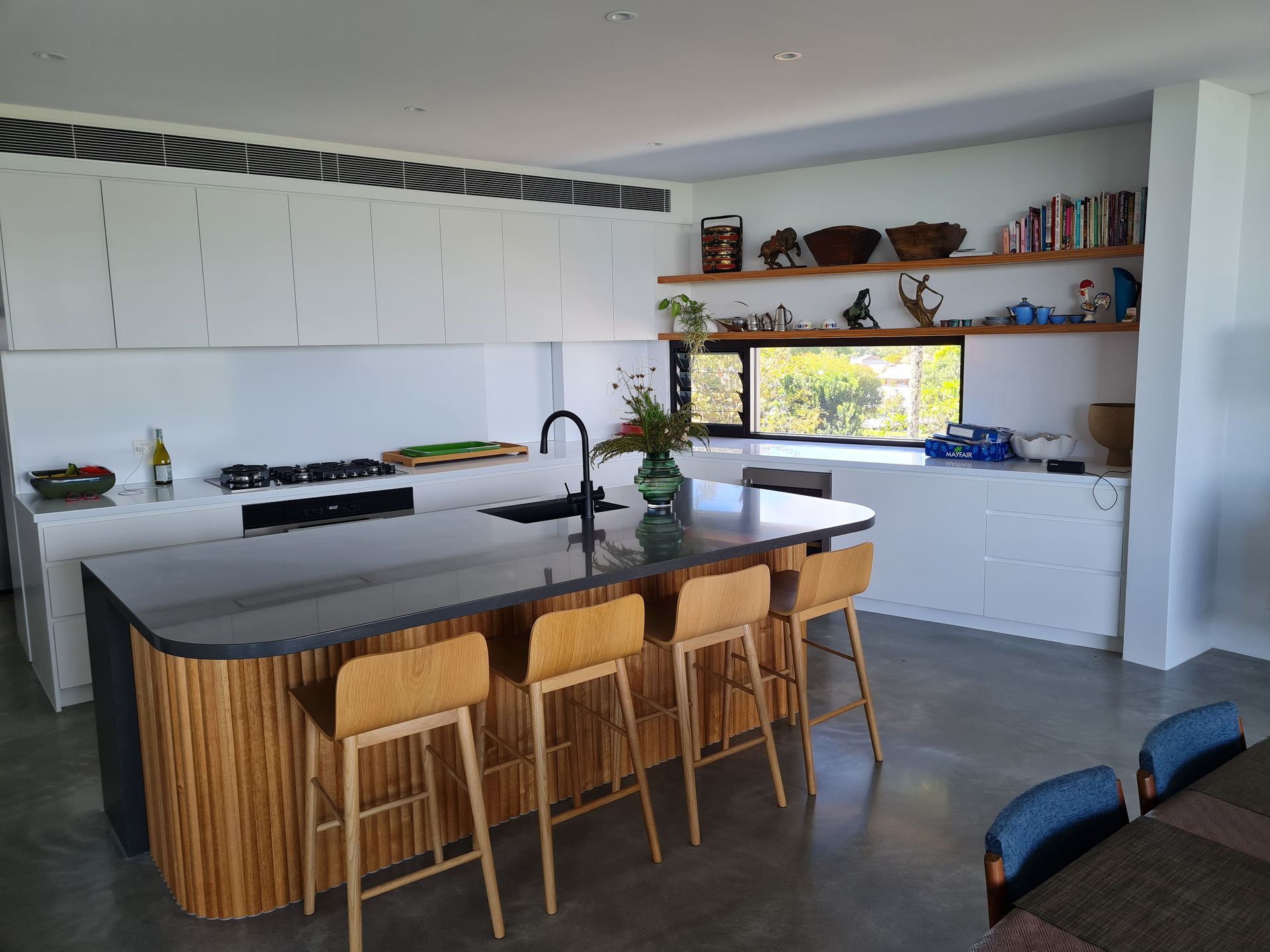 A kitchen with a large island and stools