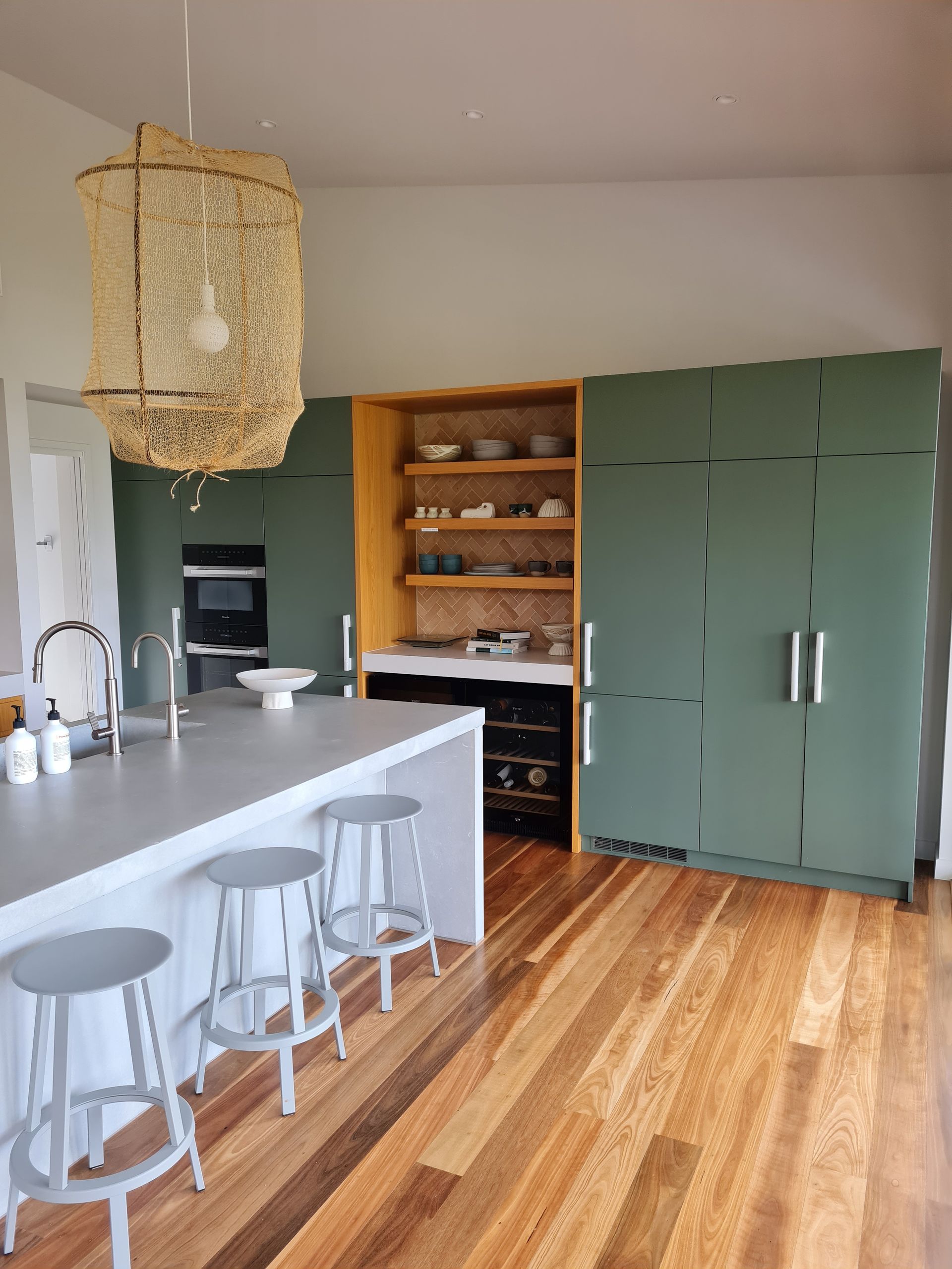 A kitchen with a large island and stools