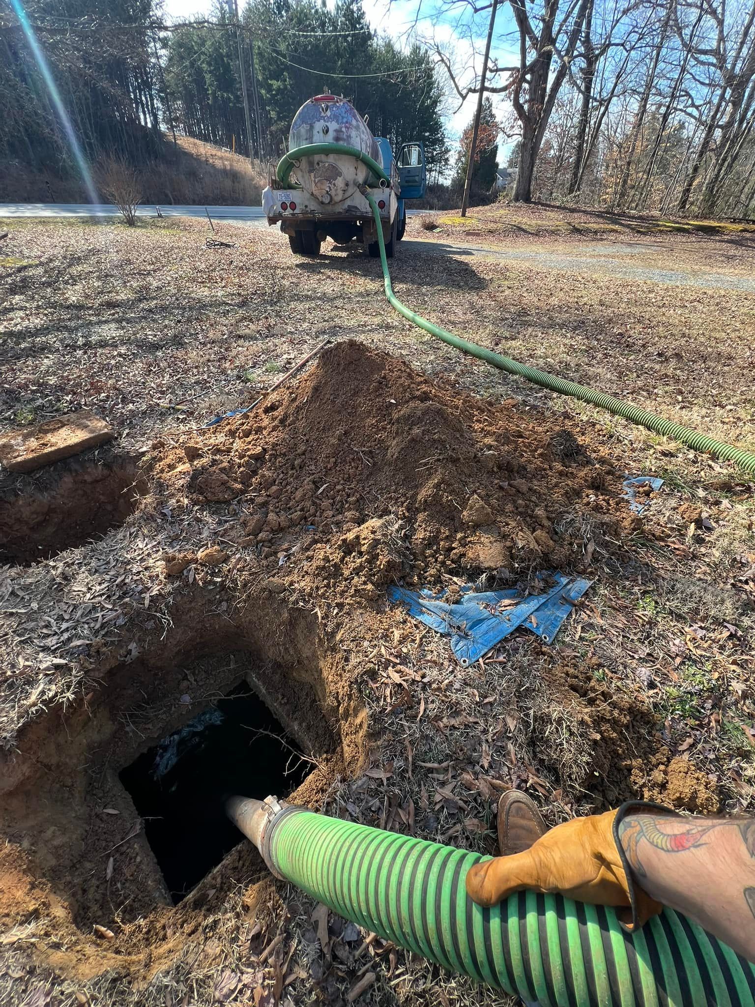 A person is pumping water into a septic tank.