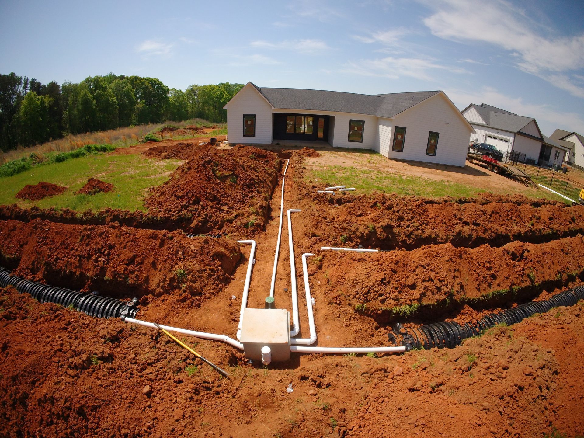 A house is being built in the middle of a dirt field