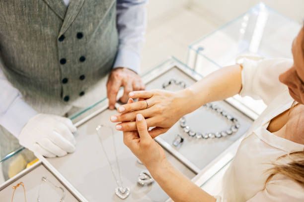 Close-up of a woman trying on a diamond ring, at a jewelry store. - Staples Jewelry | Louisville, KY