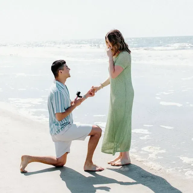 Young woman jewelry designer creating items and working with laptop at table in the studio. Young woman jewelry designer creating items and working with laptop at table in the studio.
