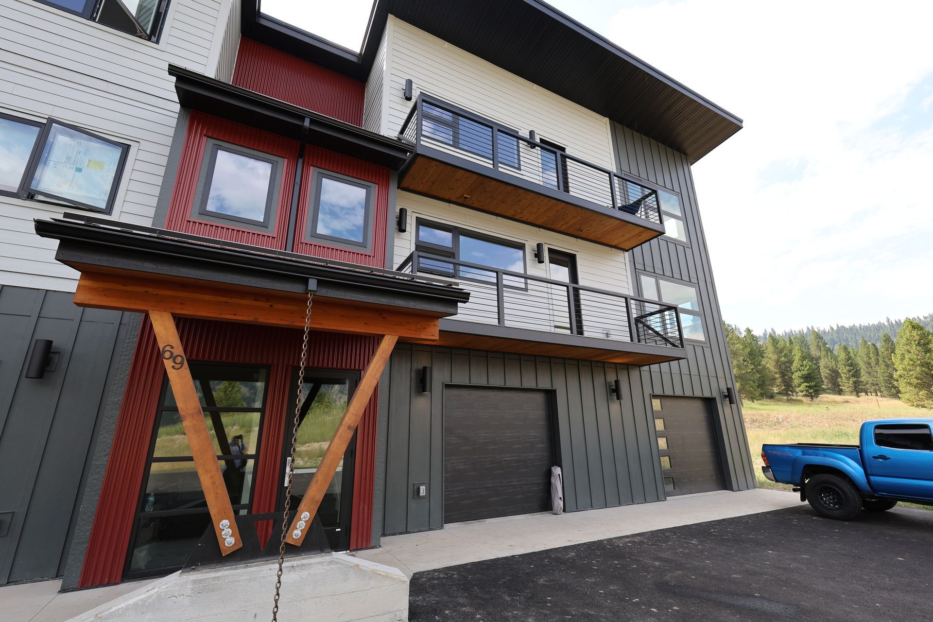 a photo of a 3 story condominium with garages on the bottom and 2 units above the garages