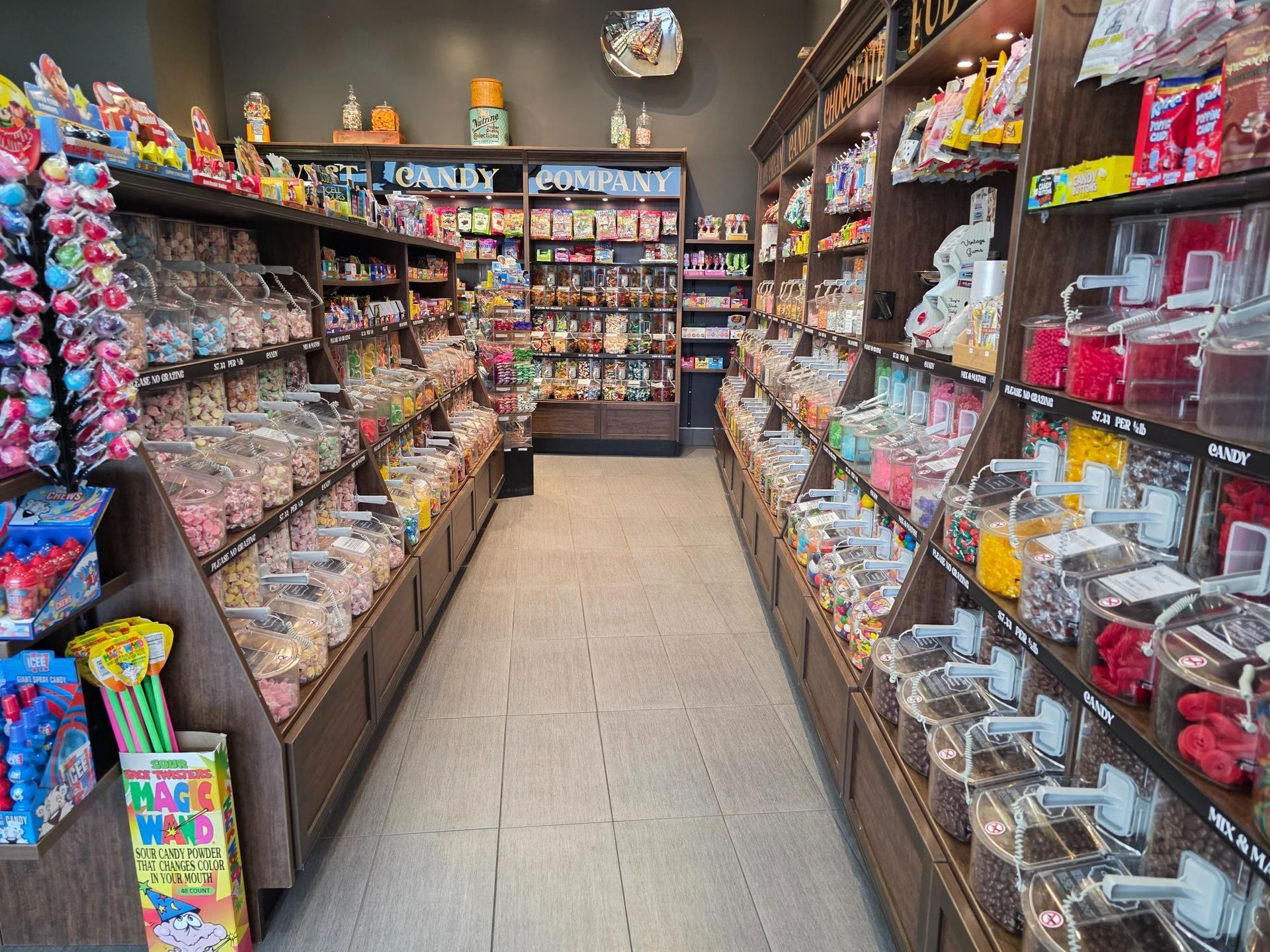 Candy store interior: Shelves filled with colorful candies, clear bins, and various treats.