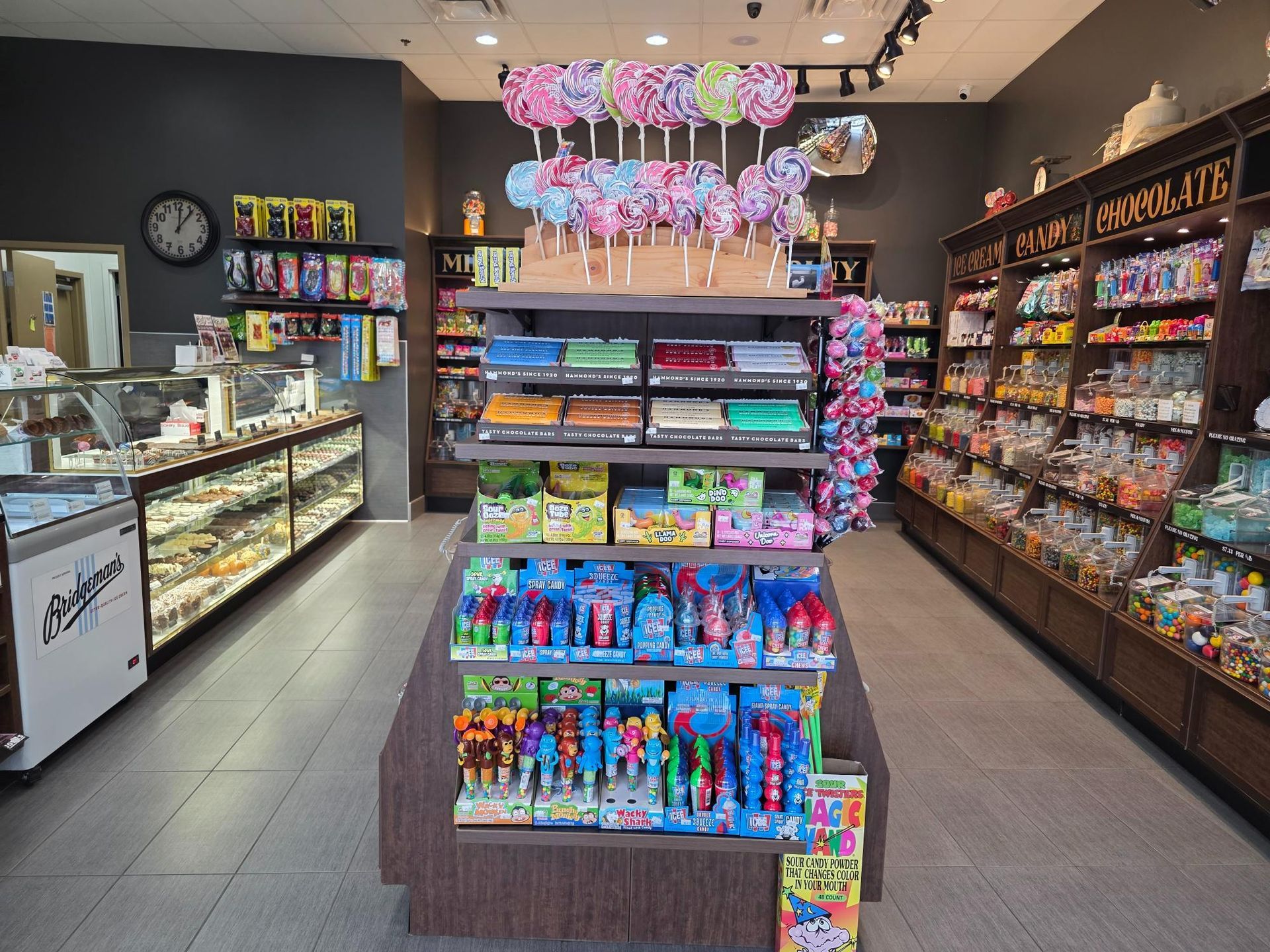 Candy store interior with shelves of colorful sweets and treats.