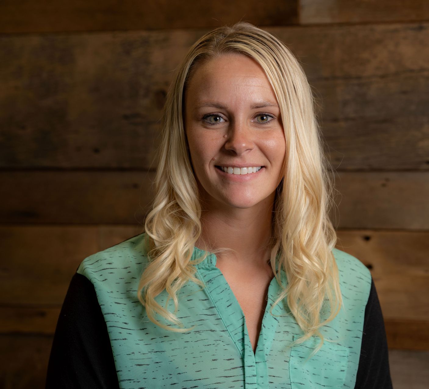 Katy Stewart, Commercial Property Manager at Cobalt Properties Group in Bend, Oregon, smiling in office.