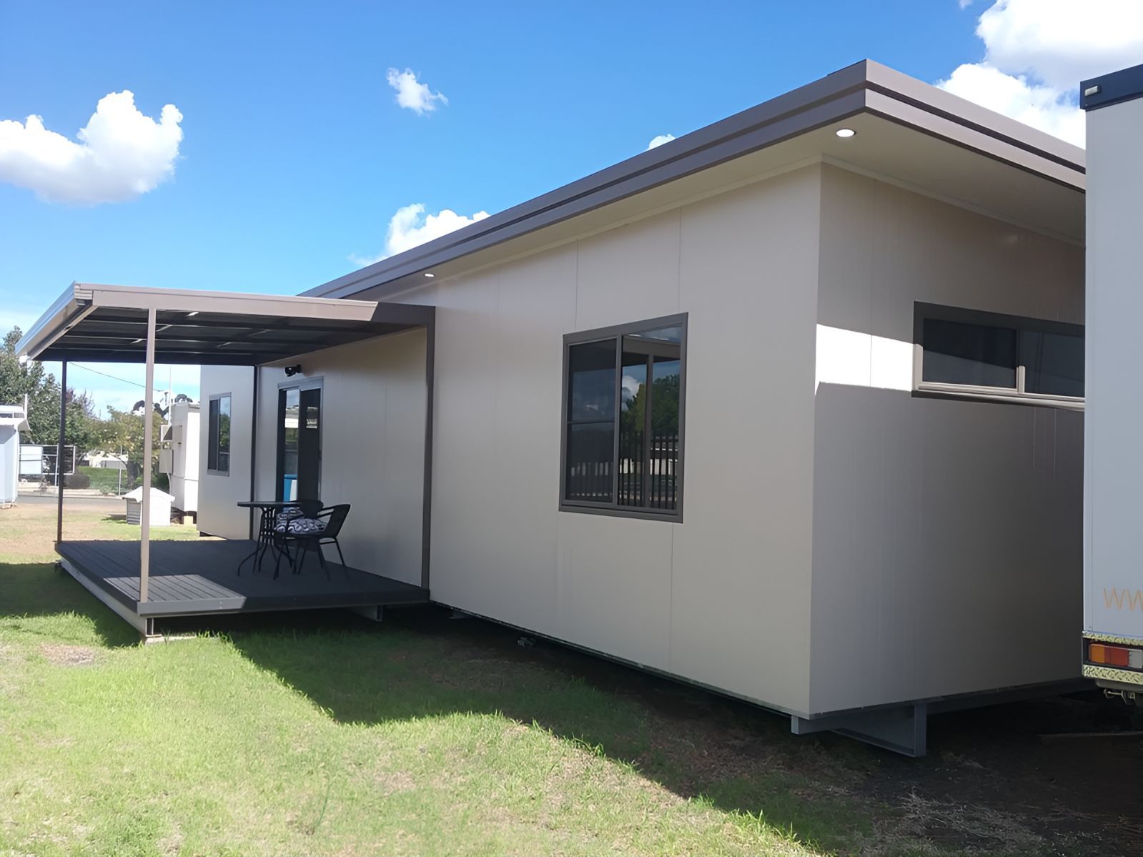 A Small House With a Porch and a Table and Chairs — OSM Transportables In Coonabarabran, NSW