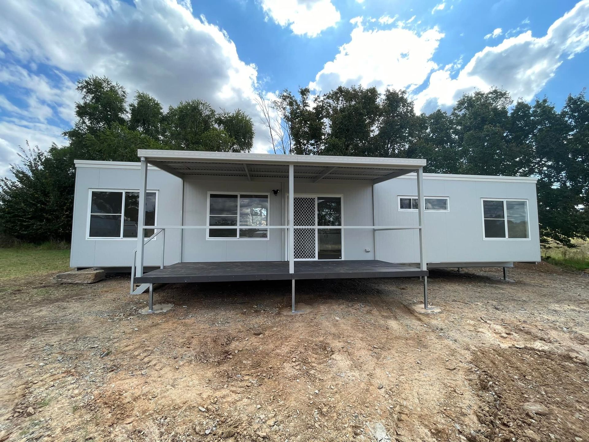 Three Towing Trucks With Portable Houses on Their Backs, Ready for Transportation — OSM Transportables In Dubbo, NSW