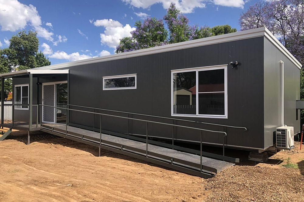 Dark Grey House With a Porch, a Long Staircase, and a Built-in Air Conditioning System — OSM Transportables In Dubbo, NSW