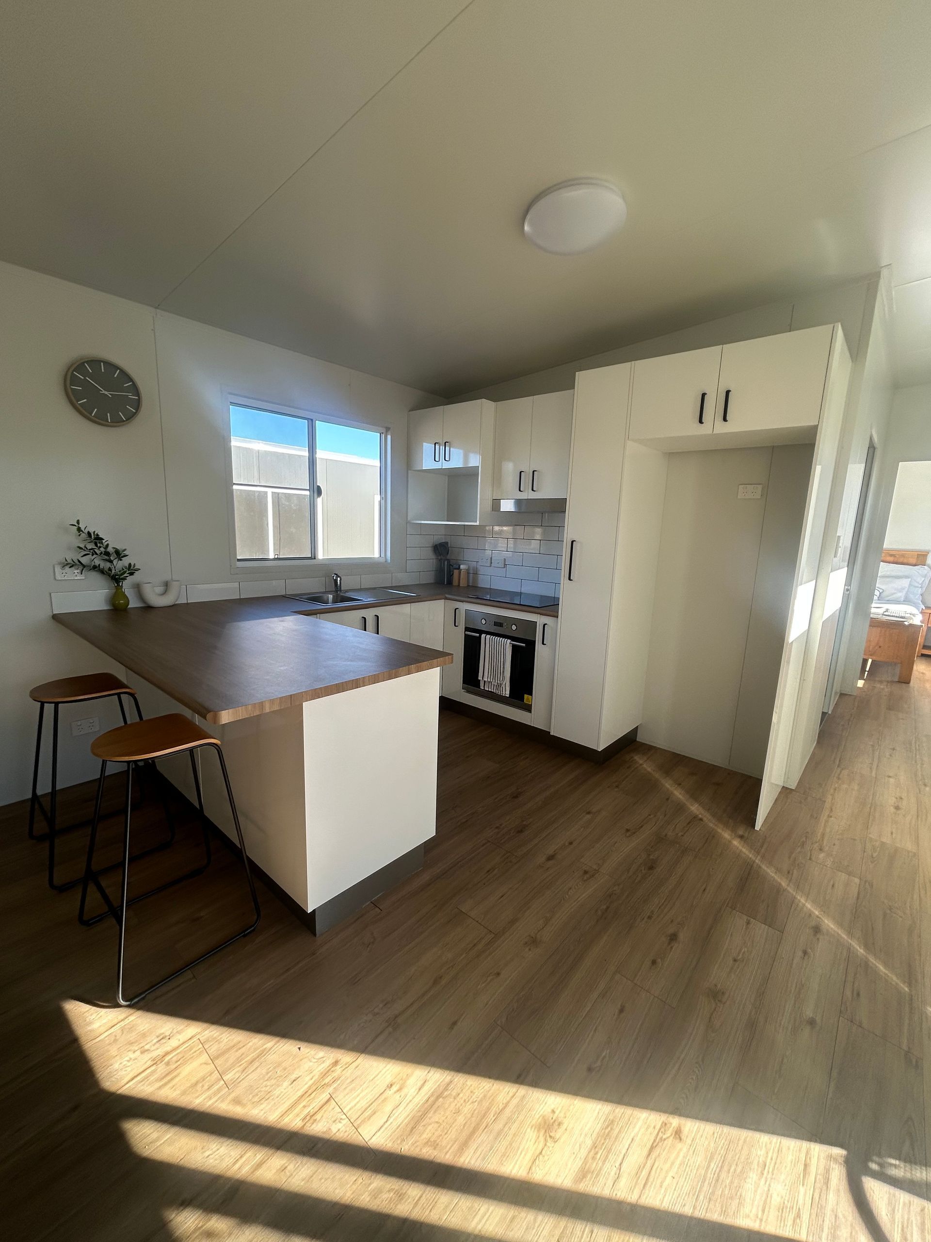 A Bright, Minimalist Kitchen With White Cabinets — OSM Transportables In Dubbo, NSW