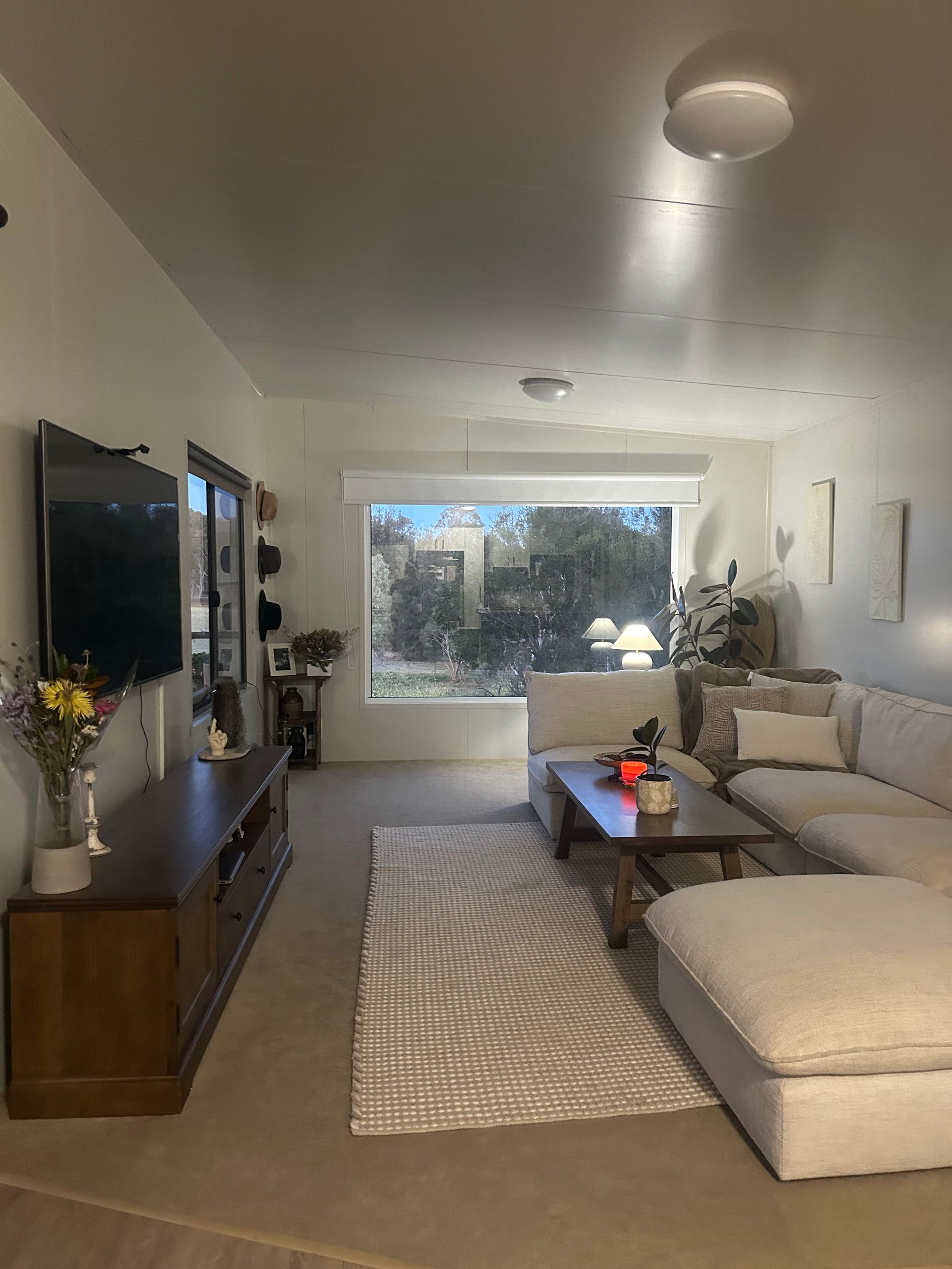A Living Room With a Brown Console, a Wall-mounted Tv — OSM Transportables In Dubbo, NSW