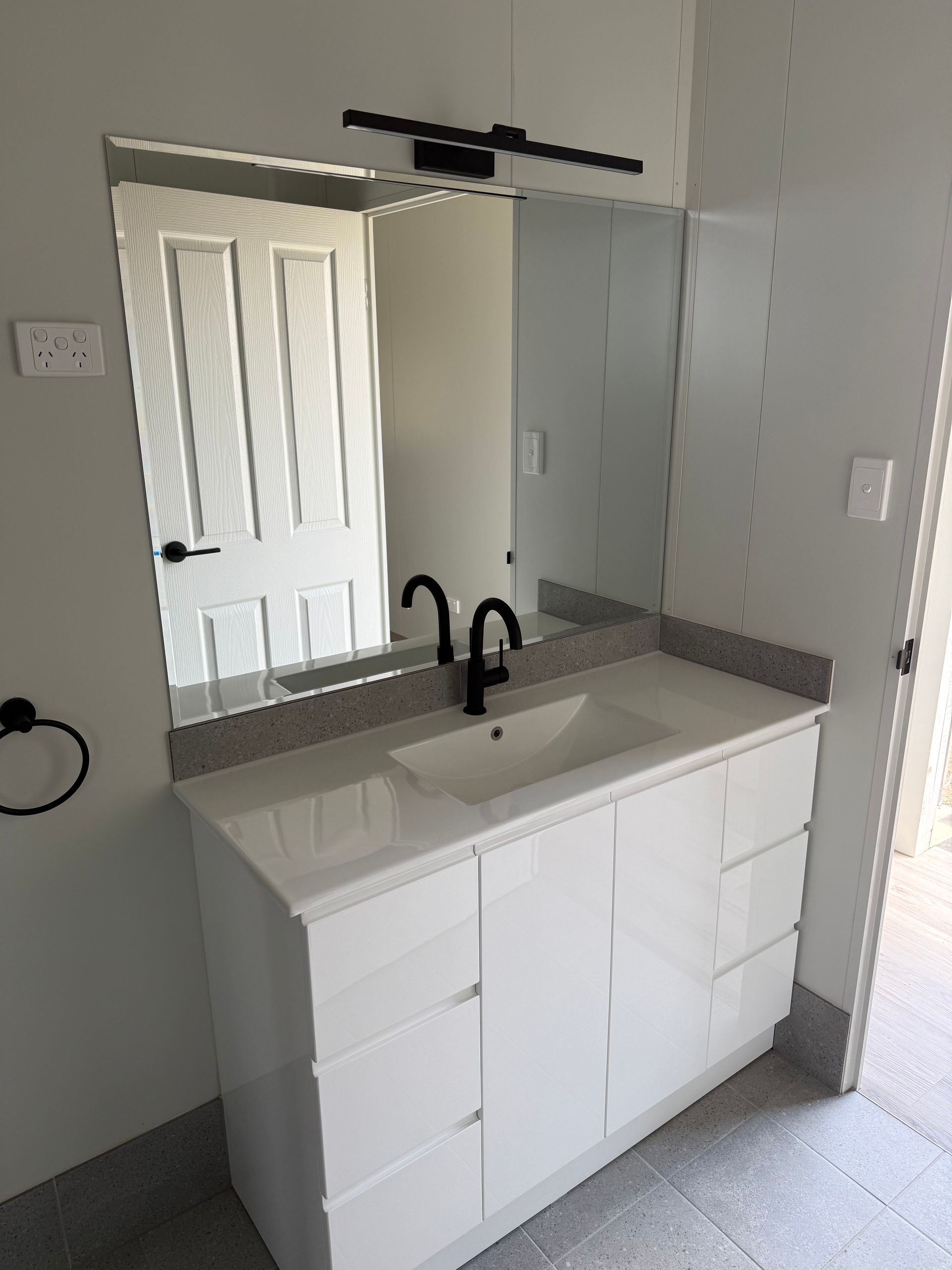 A White Bathroom Vanity With a Black Faucet — OSM Transportables In Dubbo, NSW