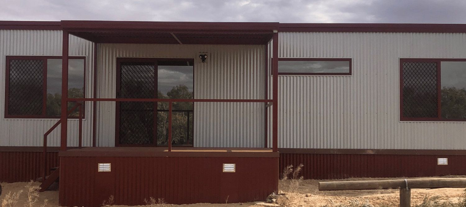Front View of White Container House With Red Porch — OSM Transportables In Dubbo, NSW