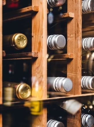 A wooden wine rack filled with bottles of wine.