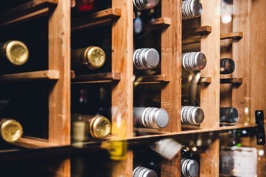 A wooden wine rack filled with bottles of wine.