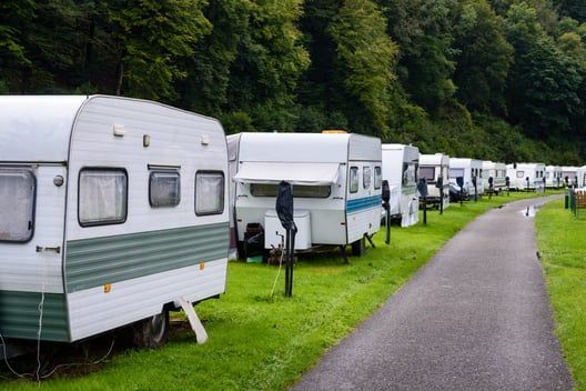 A row of caravans parked on the side of a road.