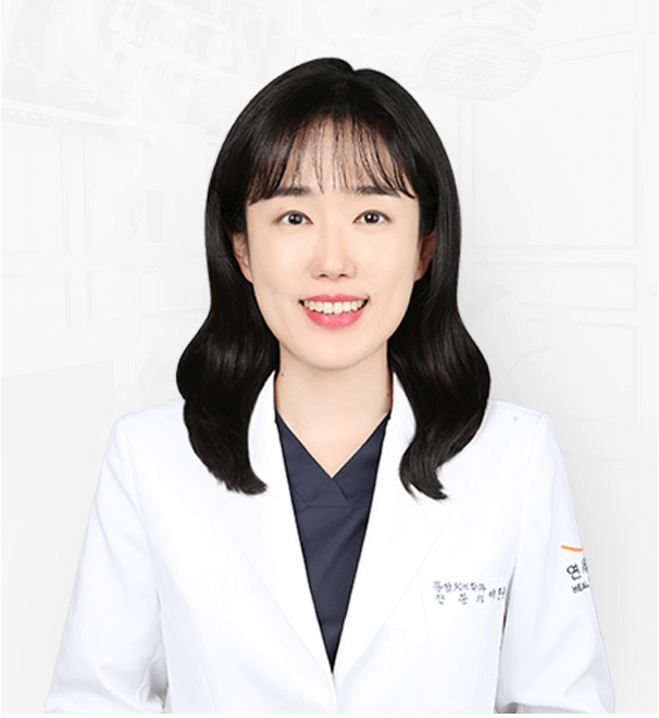 Woman in a white lab coat smiles; dark hair, light skin, neutral background, medical professional.