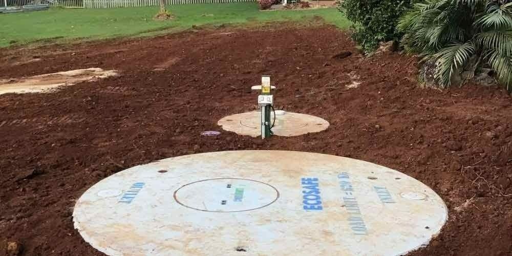 Two Concrete Circular Covers on a Brown, Earthy Ground — VR Marsden Plumbing in Red Rock, NSW