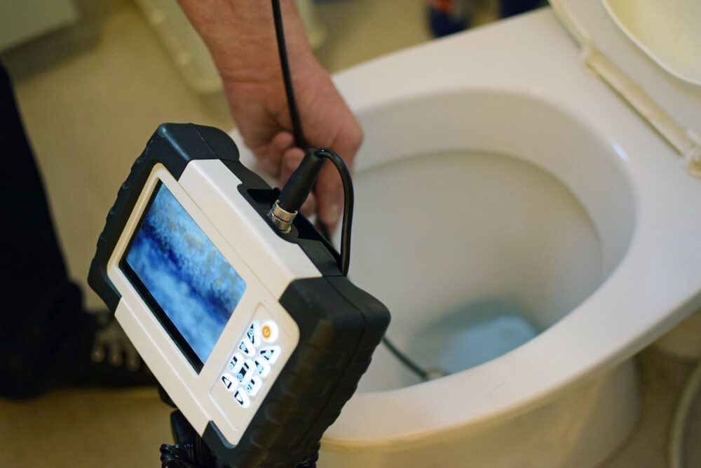 A Person Uses a Camera to Inspect a Toilet Bowl — VR Marsden Plumbing in Emerald Beach, NSW