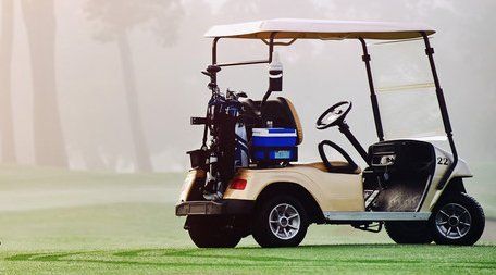 driverless golf buggy parked on grass