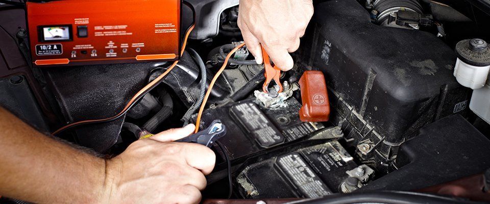 attaching cables to car battery terminals