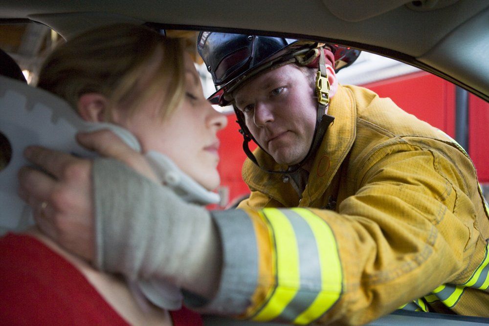 A Volunteer Rescuing a Woman in Car Crash