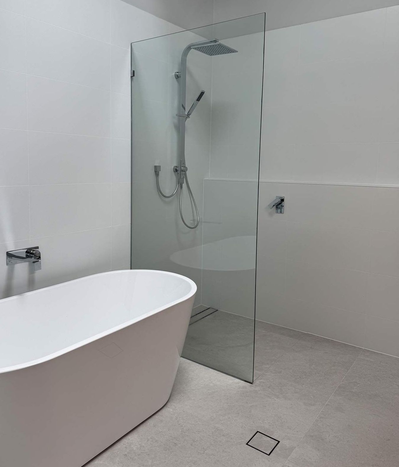 A bathroom with a bathtub and a walk in shower — Hart Projects Wollongong In Dapto, NSW