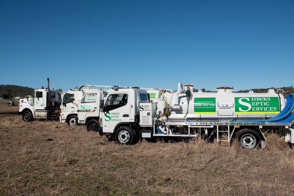 Several White Utility Trucks — Shreks Septic Services in Gowrie Junction, QLD