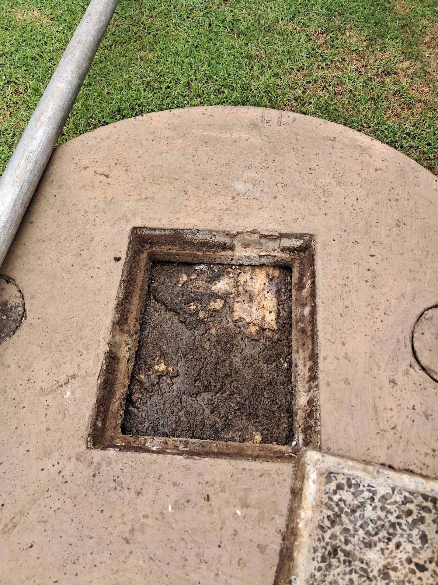 Round Tan Concrete Lid With a Square Open Access — Shreks Septic Services in Southbrook, QLD