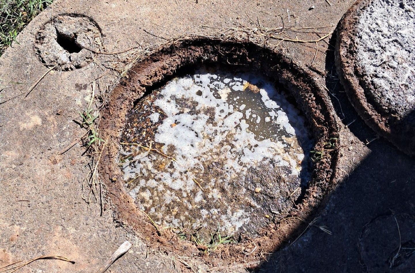 Rusty Metal Container Lid in Dirt — Shreks Septic Services in Gowrie Junction, QLD