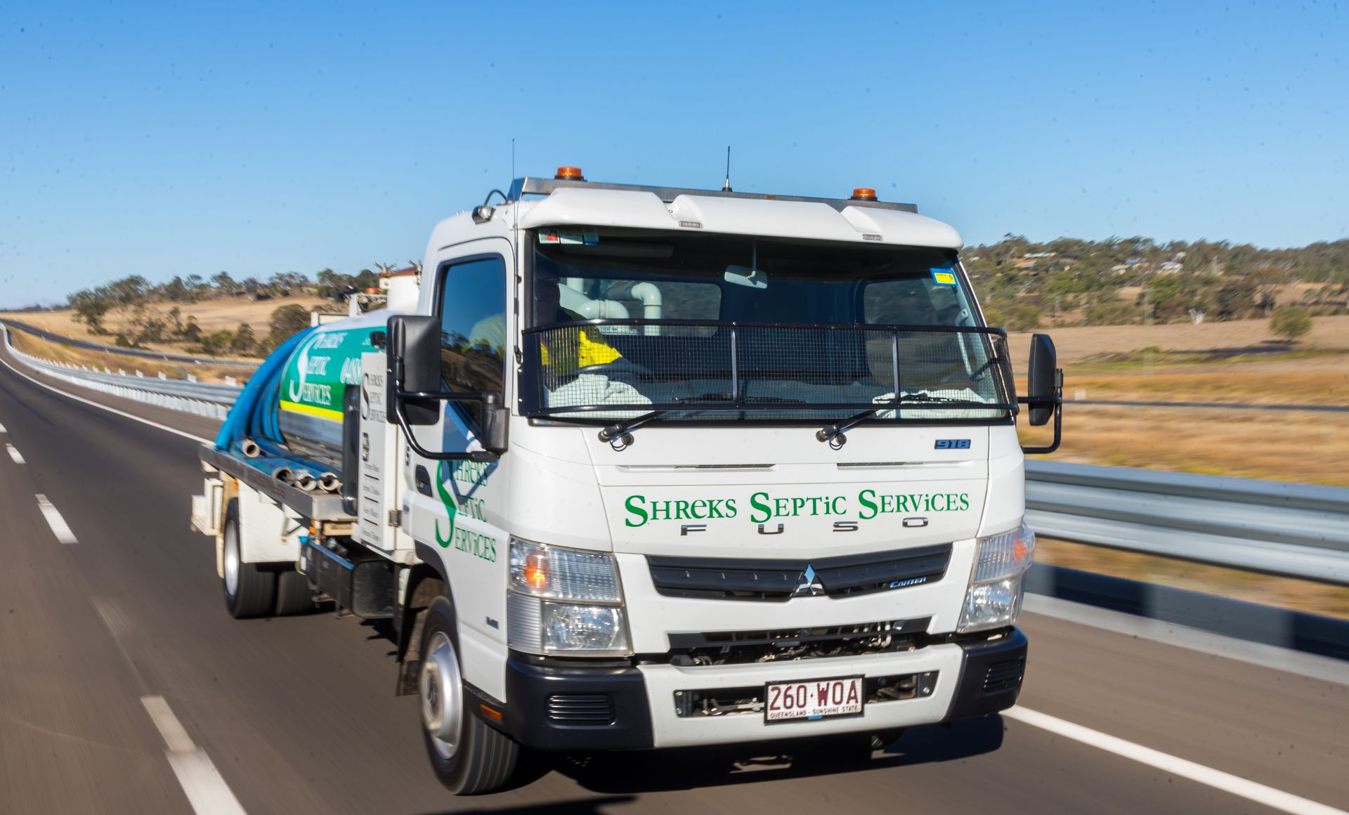 White Tow Truck Driving on a Highway — Shreks Septic Services in Gowrie Junction, QLD