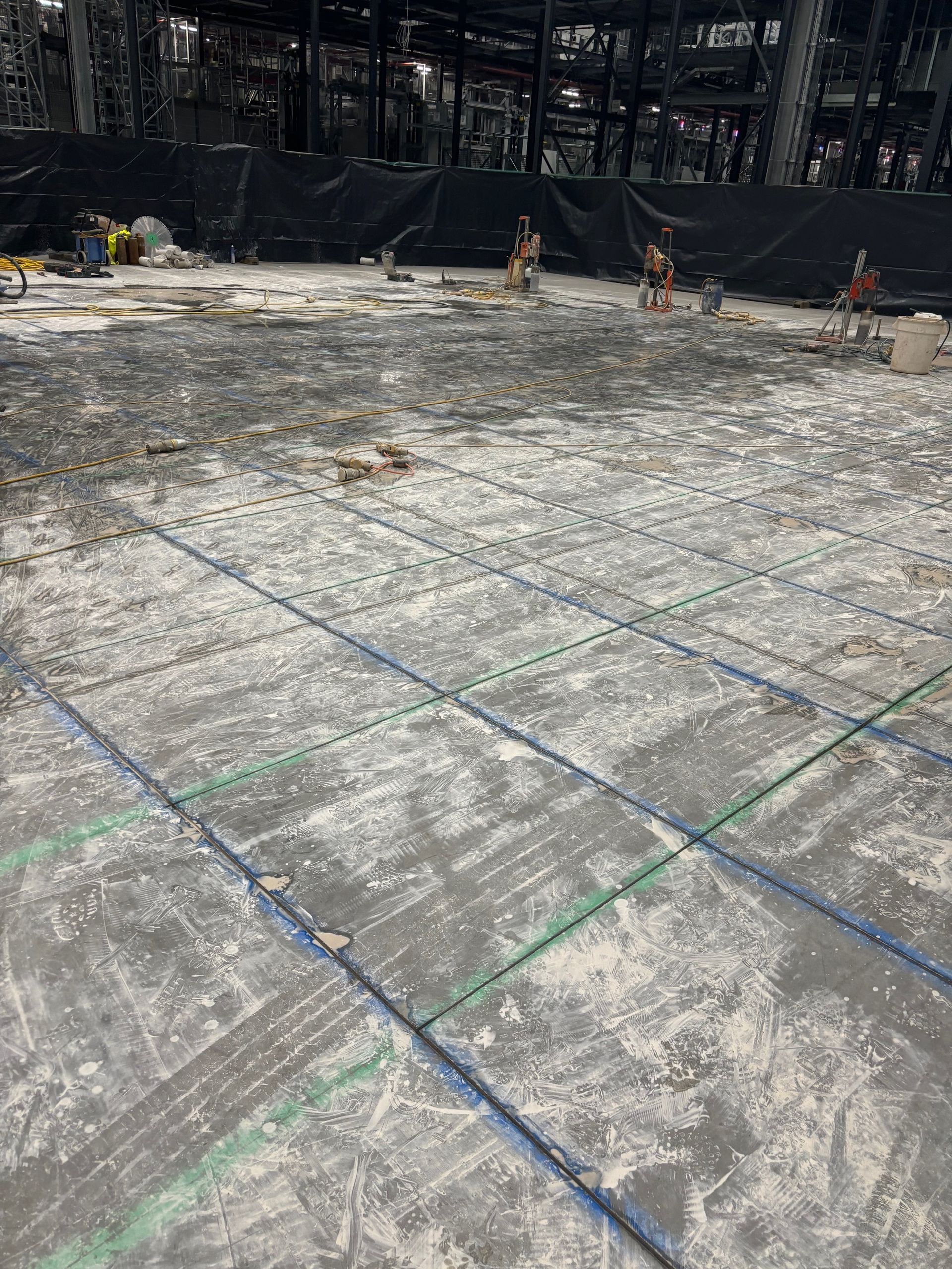 A concrete floor is being built in a building under construction.