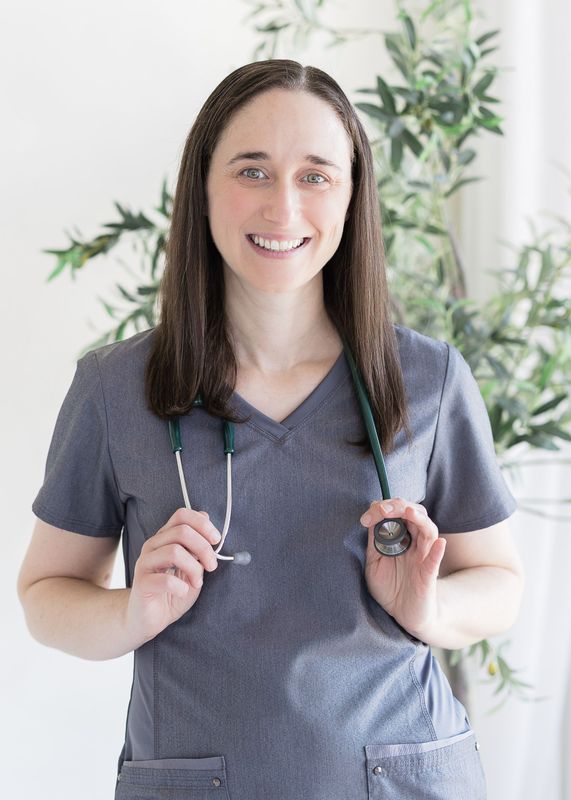 Dr. Sarah Wiersma in purple/gray scrubs, stethoscope around her neck, smiling. Indoor setting.