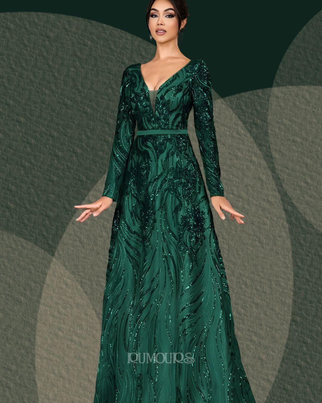 Woman in a long, emerald green sequined evening gown with long sleeves.