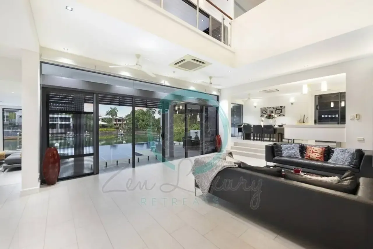 A Living Room With a Couch and a Sliding Glass Door — Zen Luxury Retreats in Darwin City, NT