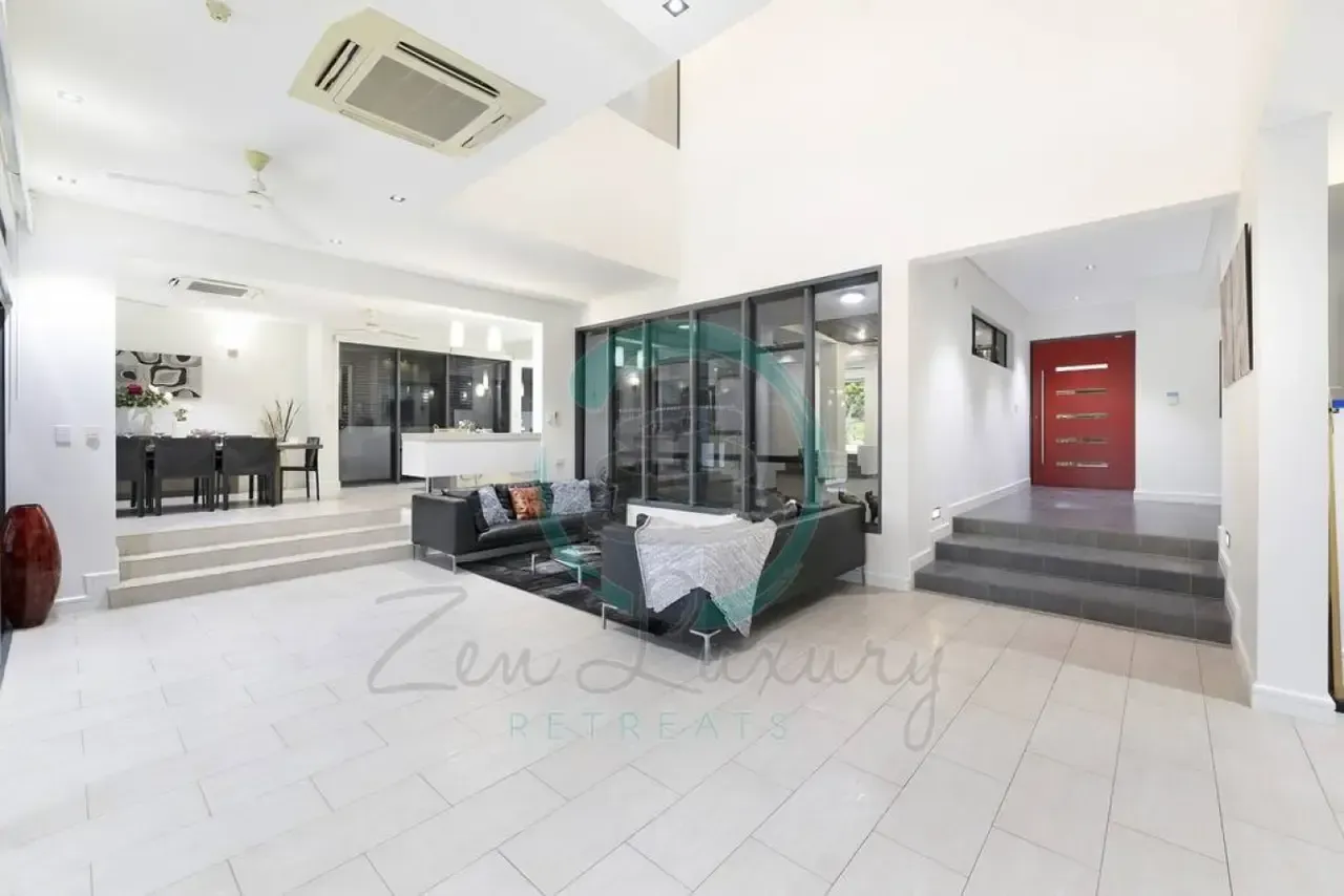 A Living Room With a Couch and Stairs in a House — Zen Luxury Retreats in Darwin City, NT