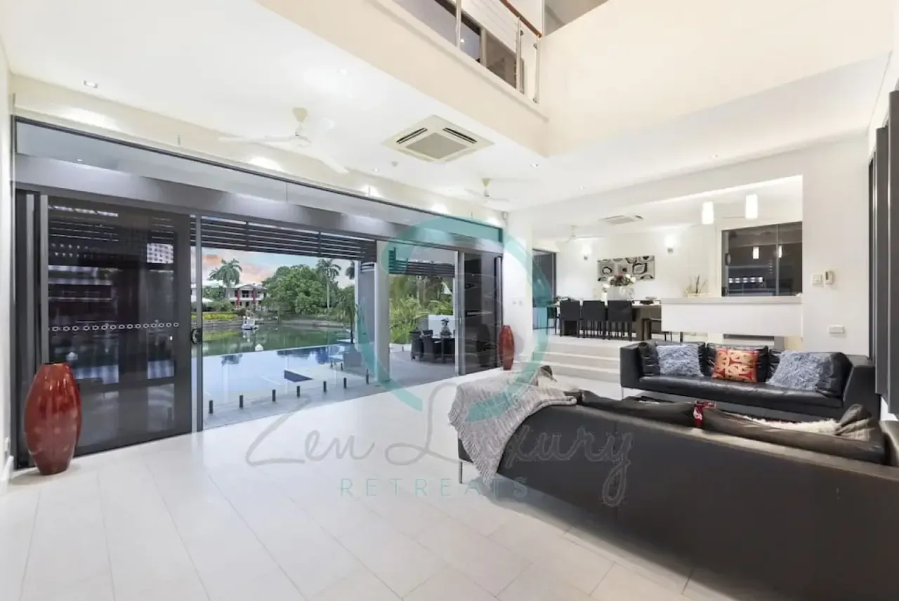 A Living Room With a Lot of Furniture and a Large Window — Zen Luxury Retreats in Darwin City, NT