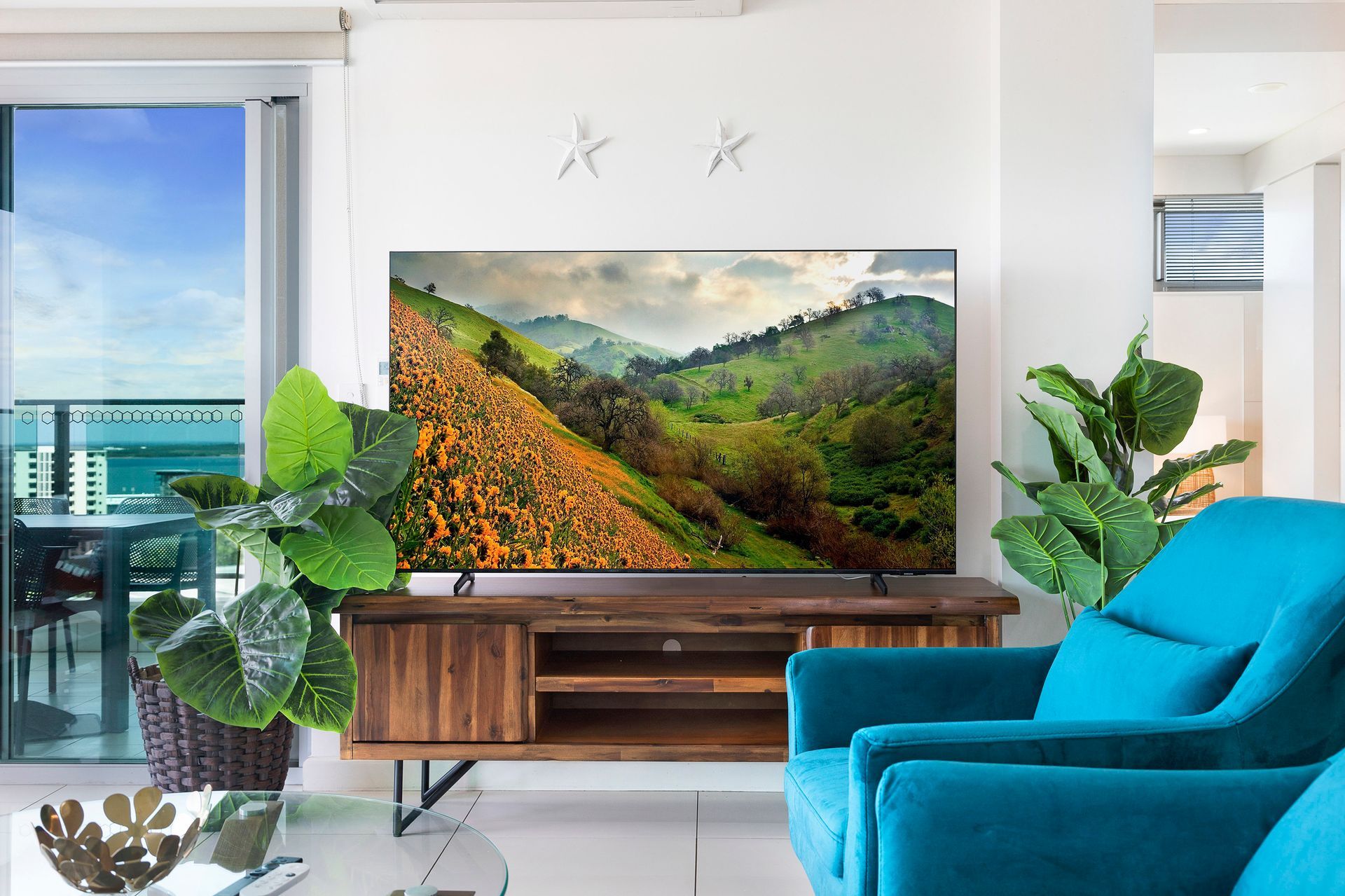 A Living Room With Two Blue Chairs and a Flat Screen Tv — Zen Luxury Retreats in Darwin City, NT