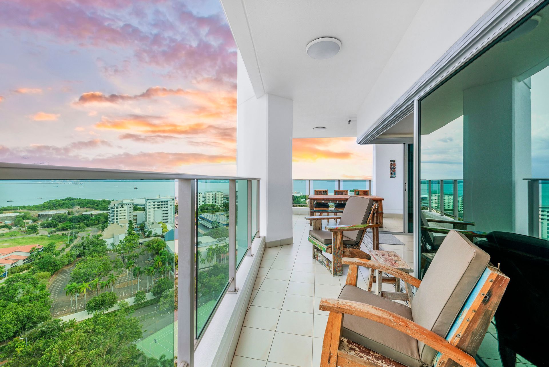 A Balcony With a View of the Ocean and a Sunset — Zen Luxury Retreats in Darwin City, NT