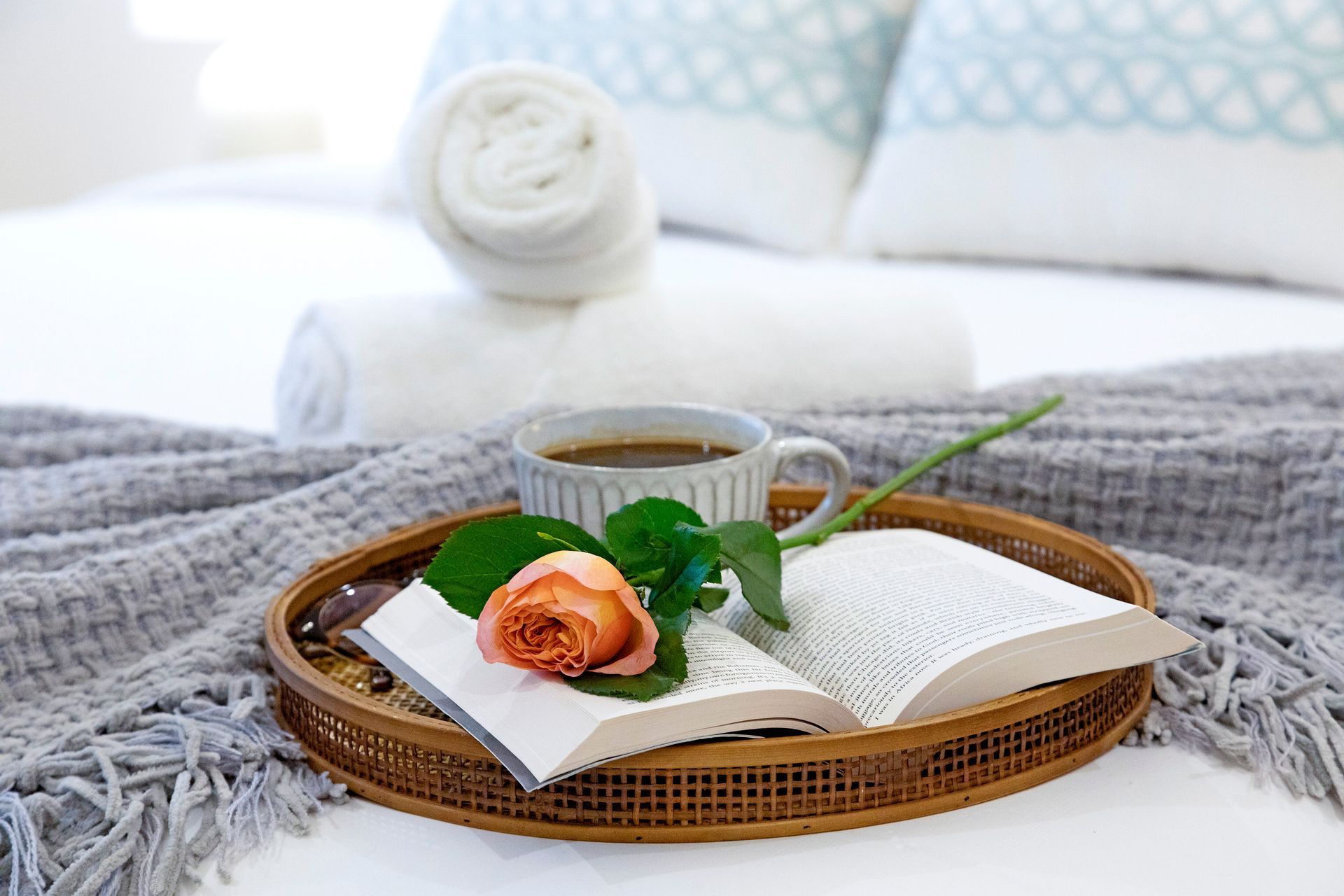 A Tray With a Cup of Coffee, a Book, and a Rose on a Bed — Zen Luxury Retreats in Darwin City, NT