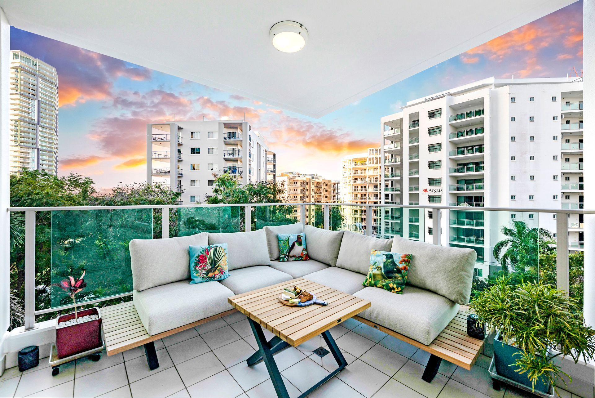 There is a Balcony With a Couch and a Table on It — Zen Luxury Retreats in Darwin City, NT