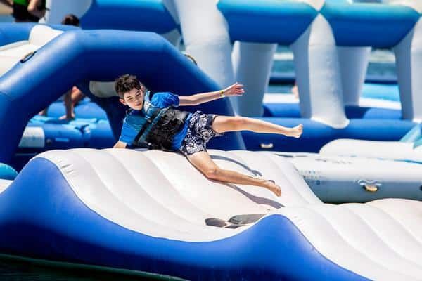 Boy Jumping Over Inflatable Obstacle — Zen Luxury Retreats in Darwin City, NT