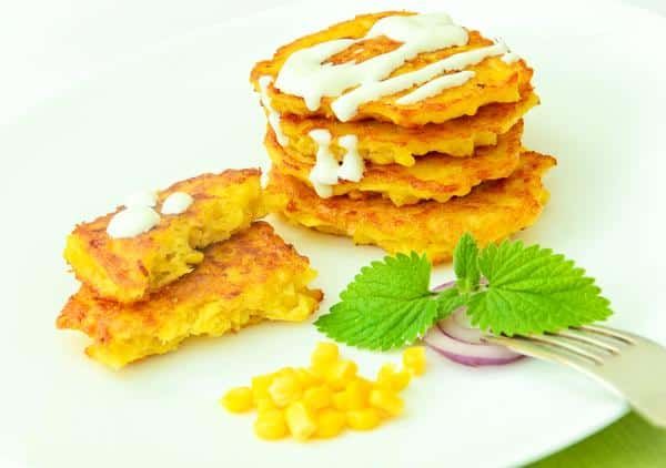 A White Plate Topped with Corn Fritters and A Fork — Zen Luxury Retreats in Darwin City, NT