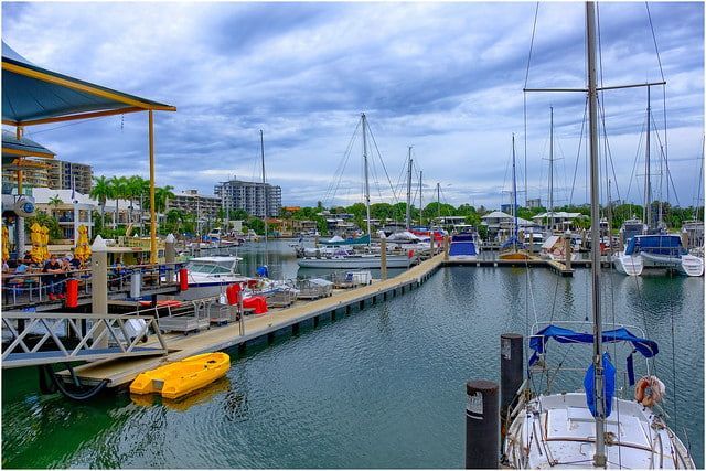 A Marina Filled with Boats and Kayaks on A Cloudy Day — Zen Luxury Retreats in Darwin City, NT