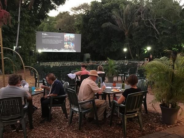 People Enjoy Nice Food While Watching on an Outdoor Cinema — Zen Luxury Retreats in Darwin City, NT