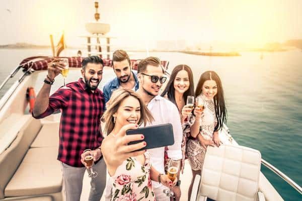 A Group of People Are Taking a Selfie on A Boat — Zen Luxury Retreats in Darwin City, NT