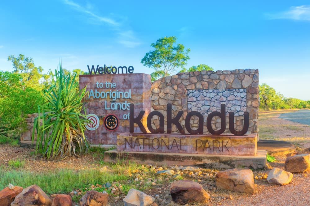 A Welcome Sign for Kakadu National Park Is Surrounded by Rocks and Trees — Zen Luxury Retreats in Darwin City, NT